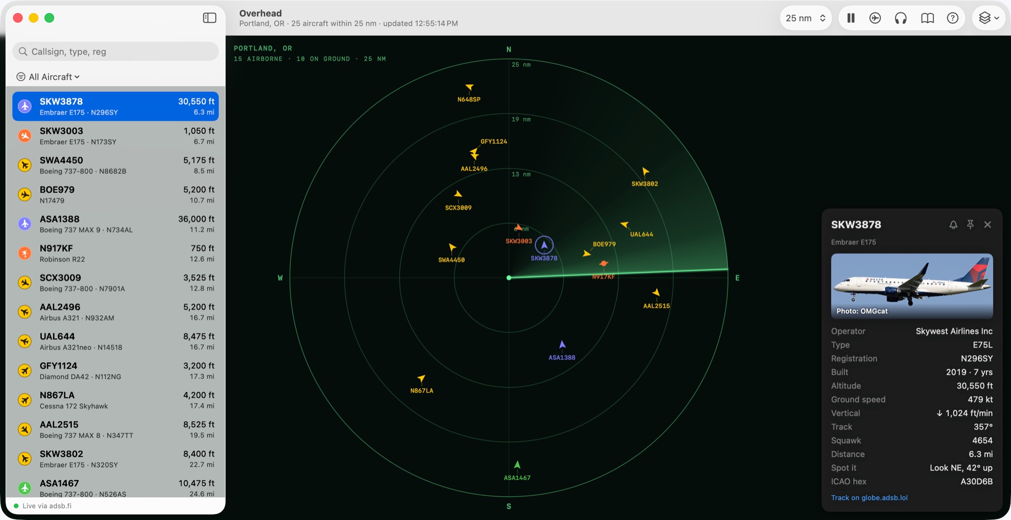 Overhead as a radar scope: aircraft on green range rings, callsigns on leaders, a card for one.